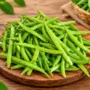 Fresh Green Cluster Beans (Goruchikkudu / Guar Beans) Arranged on a Wooden Board